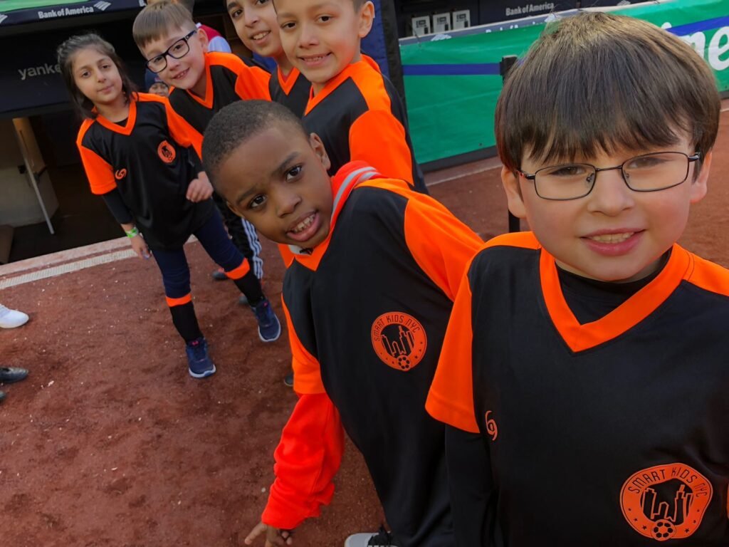 Players from are internal league attended an NYC FC game and were took a photo pitch side.