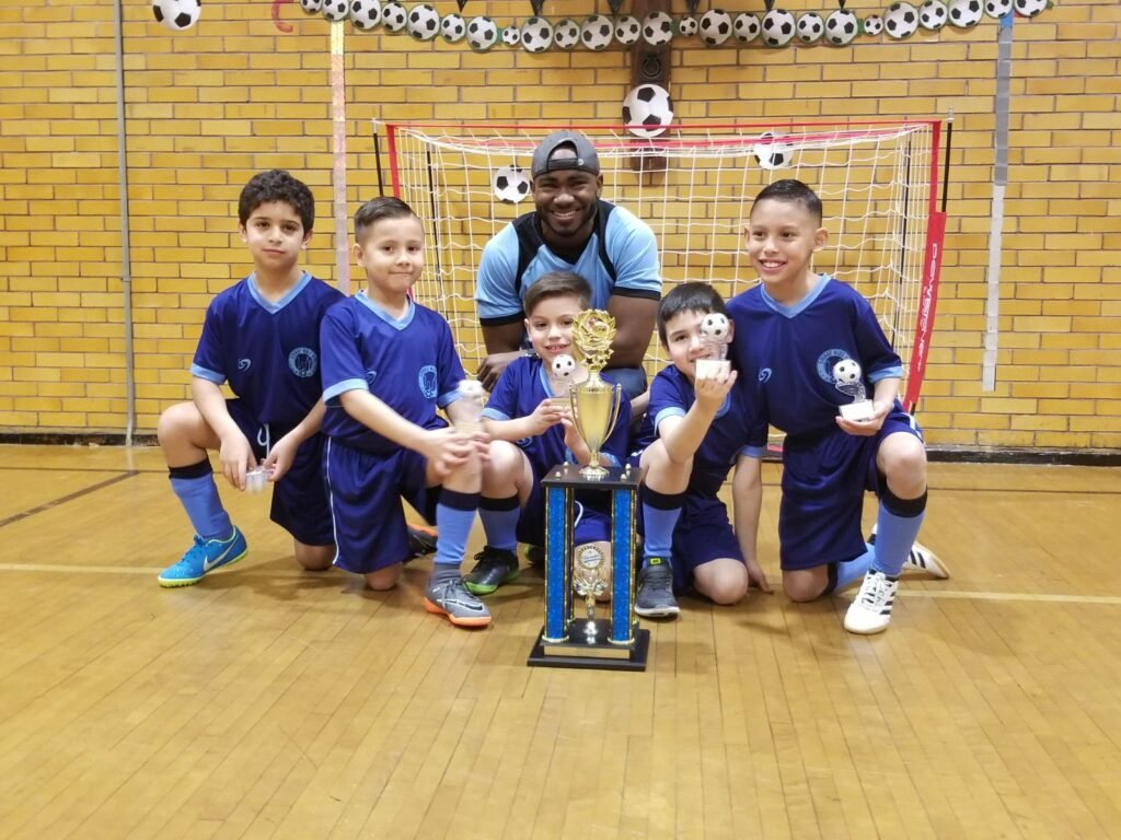The lions, one of the Internal League (Smart Kids) teams, are group together to take a picture after winning the indoor season.