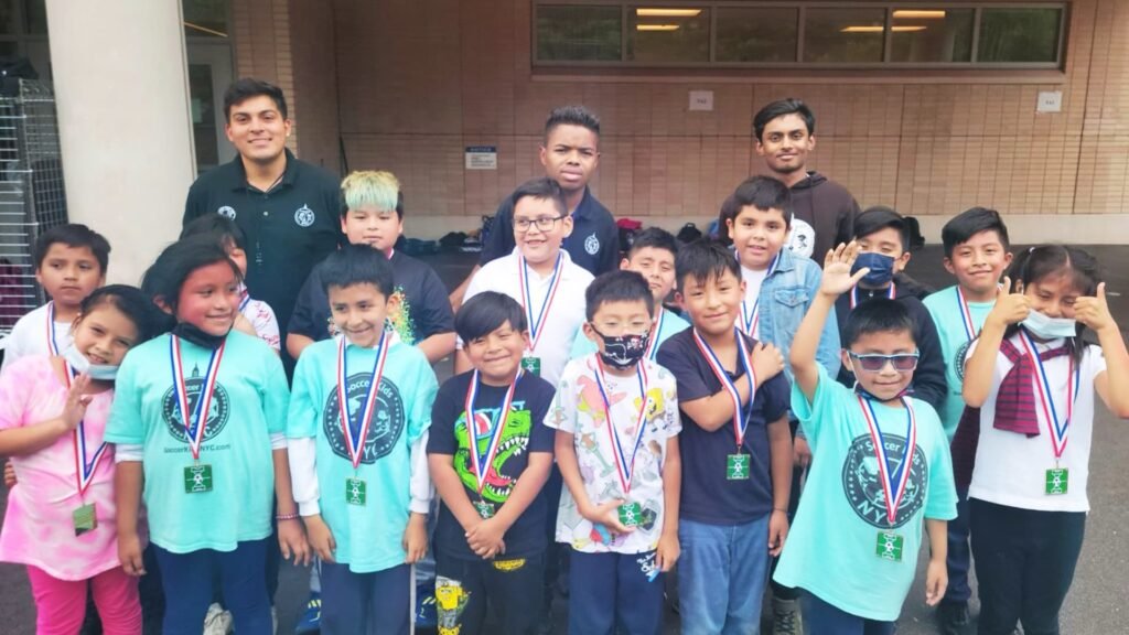 Students from a local school are taking a group photo with the medals they received for completing the instructional program.