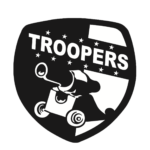 The Troopers Logo is in the shape of a shield. Inside the shield is a cannon. Above the cannon is the name of the team, "Troopers," alongside 11 stars.